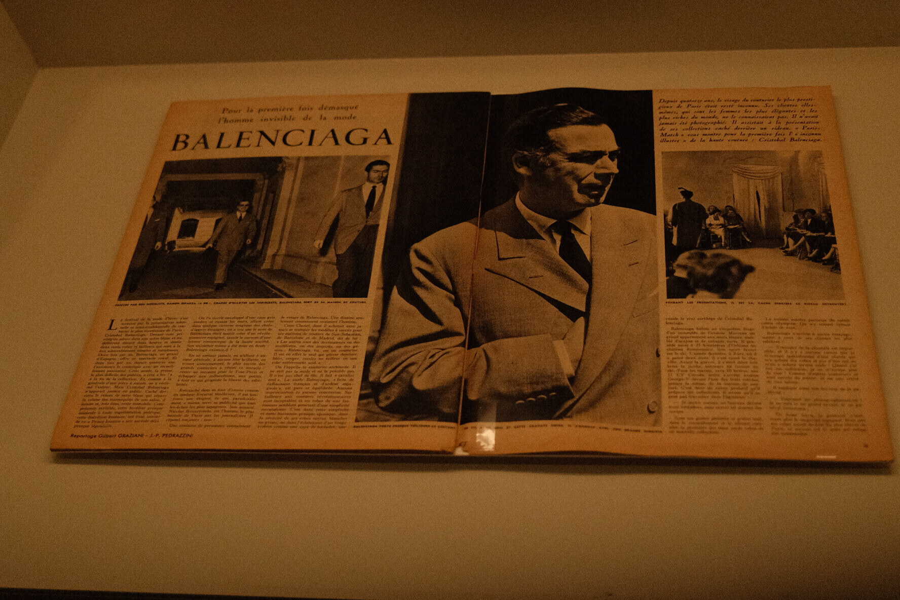 Open vintage French magazine with a large portrait of a suited man and smaller fashion photographs.